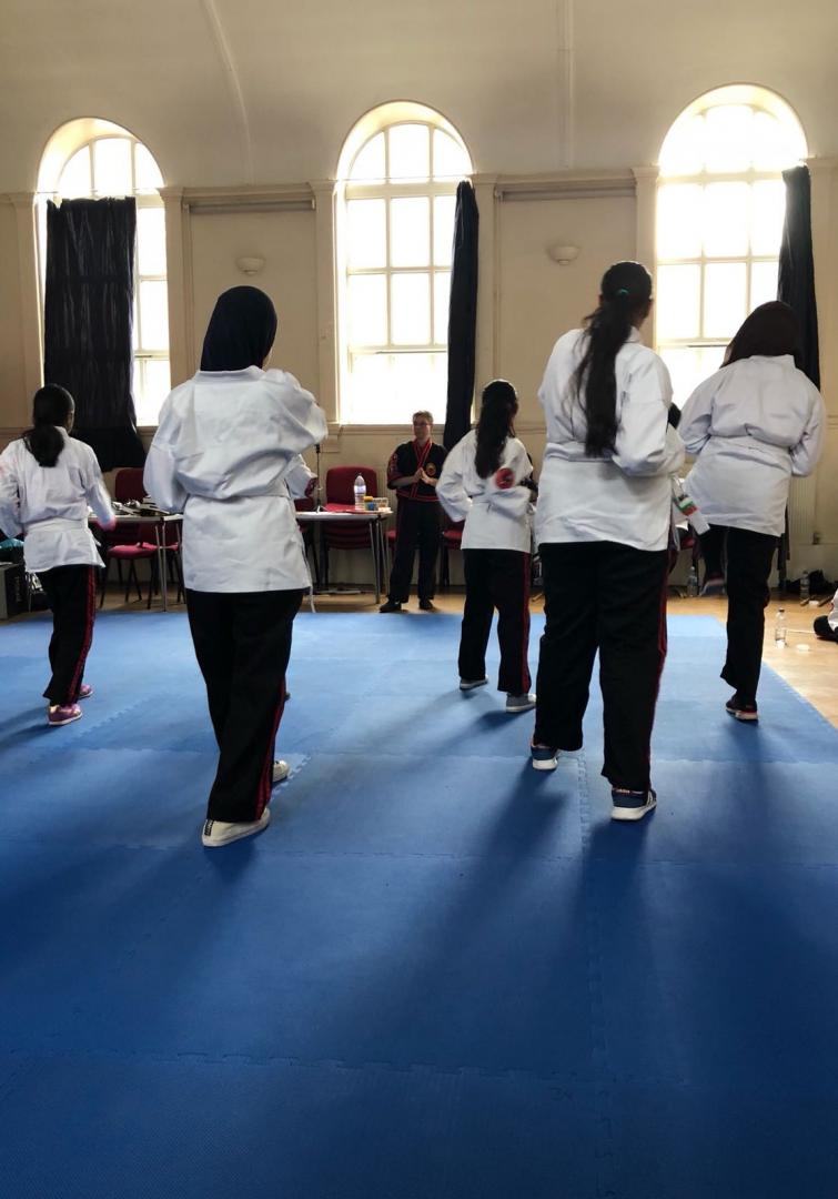 A group of young adults learning karate